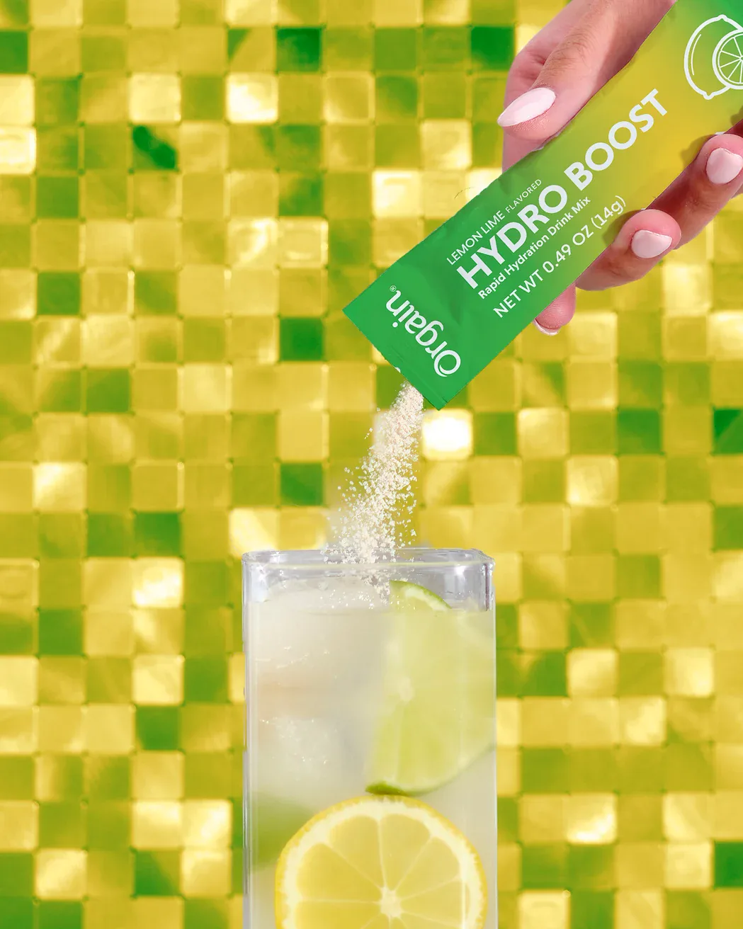 Orgain Lemon Lime Hydro Boost stick pouring into an iced glass