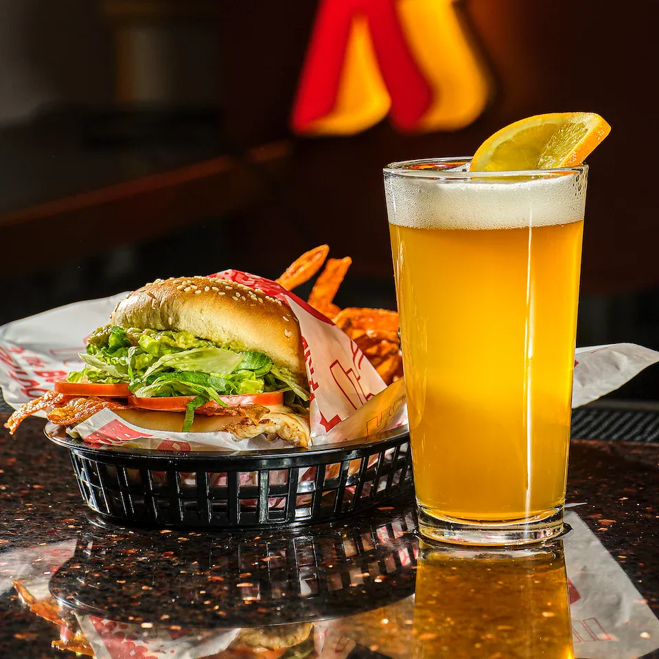 Red Robin burger basket and beer on a restaurant counter