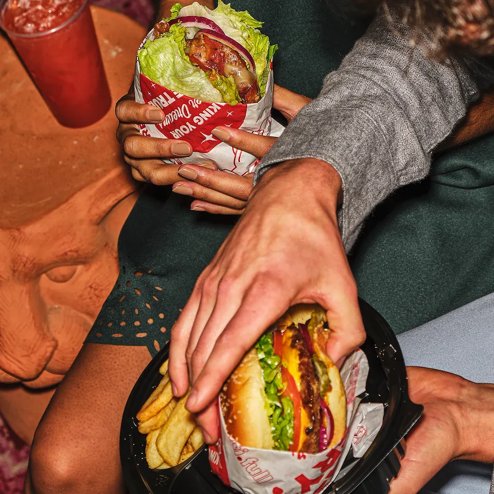 Overhead view of friends sharing Red Robin burgers and fries