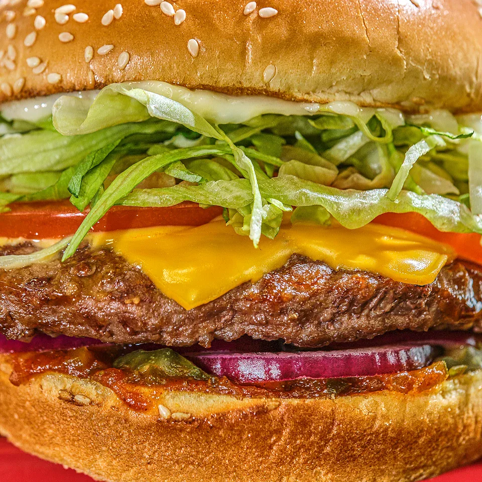Close-up layers of a Red Robin cheeseburger